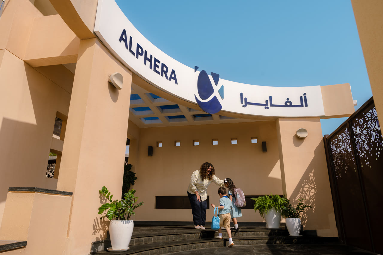 A family arrives through Alphera’s main entrance.